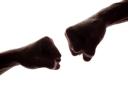 Men's fists young and aged, clashed, standoff - silhouette, isolate