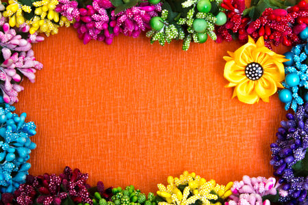 Frame of bright artificial flowers - multi-colored, beautiful background