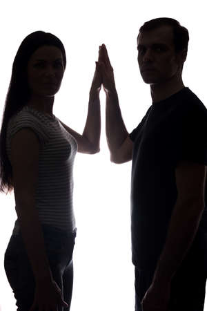 Faces women and men across from, brother and sister - vertical silhouetteの写真素材