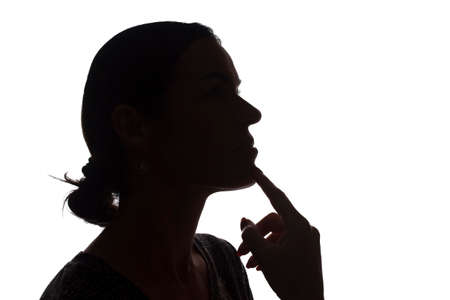 Portrait of a young woman, pensive, thinking side view - silhouette, isolatedの写真素材