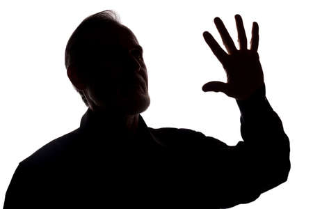 The old of a young man covers his face, protest - silhouette, concept without commentの写真素材