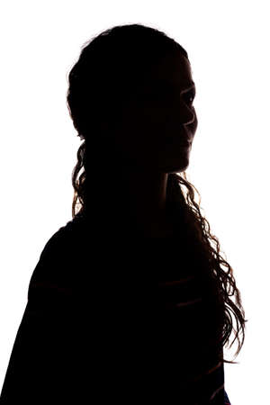 Young woman look ahead with flowing hair - isolated silhouetteの写真素材