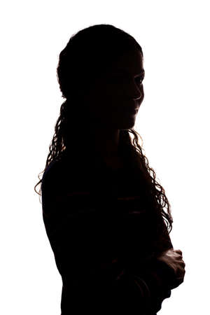 Young woman look ahead with flowing hair - isolated silhouetteの写真素材