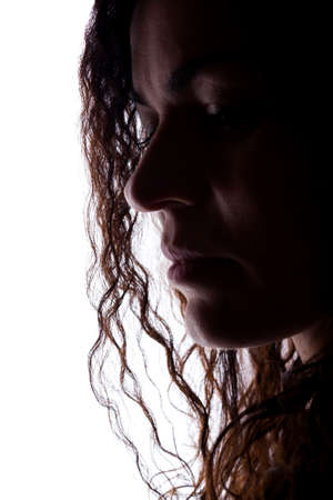 Young woman look ahead with flowing hair - isolated silhouetteの写真素材