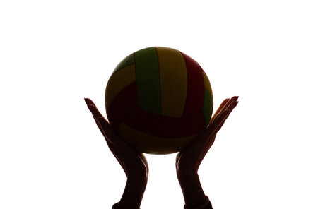 Dark silhouette of ball in young female hands, sport - isolate, white backgroundの写真素材