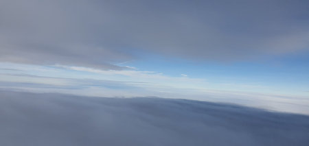 Clouds and sky through an aircraft window