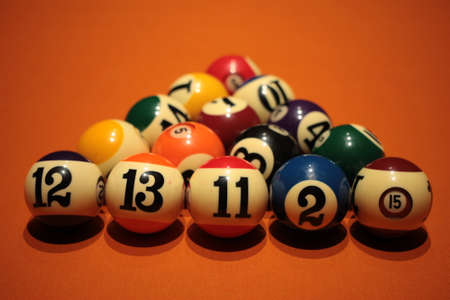 Pool balls pyramid on orange cloth for eightball gameの写真素材