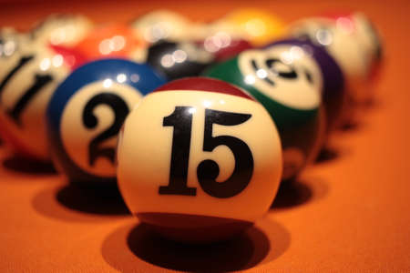 Pool ball number 15 extreme close-up on blurred background pyramid of billiard ballsの写真素材