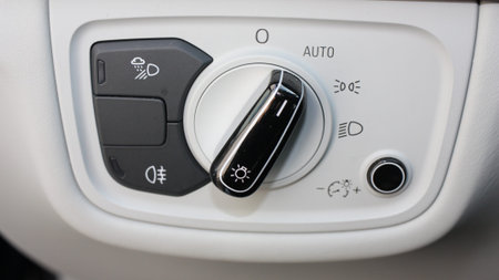 Car headlight and tail light switch control buttons close-up
