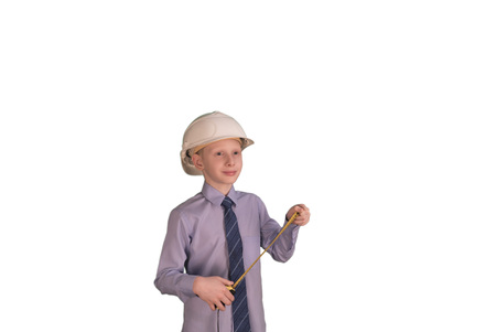 Smiling little boy wearing white hard hat and necktie with shirt on while backgroundの写真素材