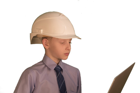 Smiling little boy wearing white hard hat and necktie with shirt on while backgroundの写真素材