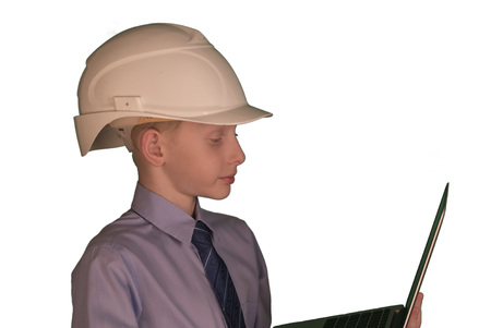 Smiling little boy wearing white hard hat and necktie with shirt on while backgroundの写真素材