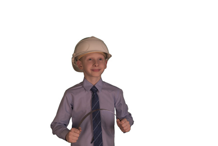 Smiling little boy wearing white hard hat and necktie with shirt on while backgroundの写真素材