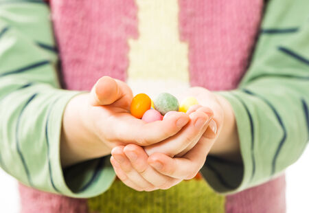 boy holding candies in open palmsの写真素材
