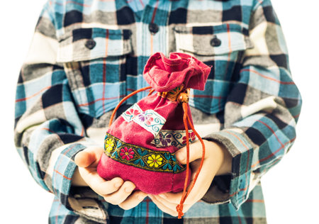 boy holding colorful bag in open palmsの写真素材