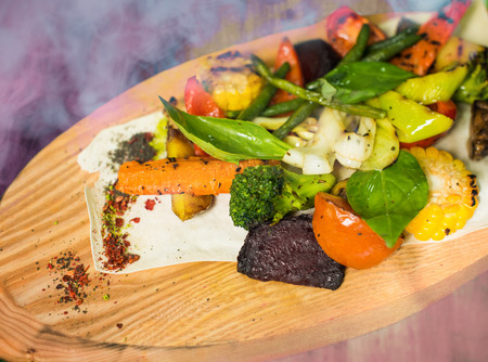 cooked vegetables on wooden standの写真素材