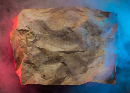 wrinkled paper in colorful smoke backgroundの写真素材