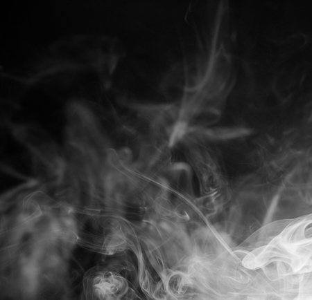 white smoke isolated on black backgroundの写真素材
