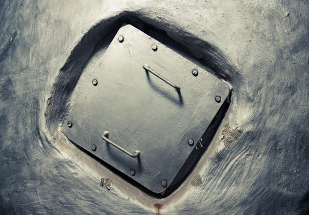 square manhole cover inside wallの写真素材