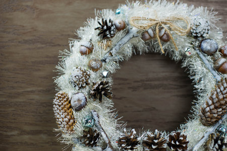 beautiful white Christmas wreath on brown wooden backgroundの写真素材
