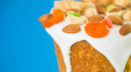 Easter holiday cake decorated with fruits and nuts isolated on blue background
