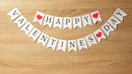 Happy Valentines day white flags garland on wood background with copy space. Love, Valentine's,...