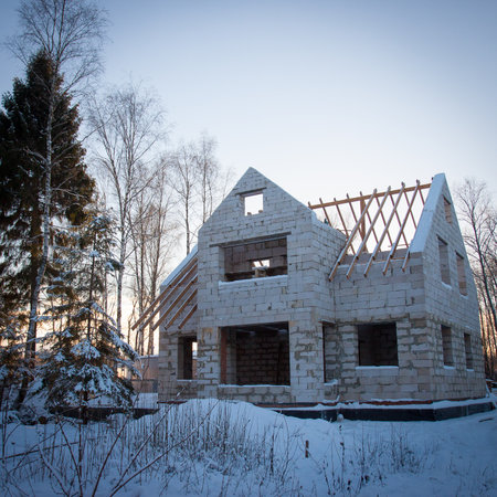 The construction of country house on winterの写真素材