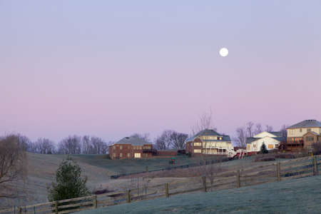 Moonset over a suburban neighborhoodの写真素材