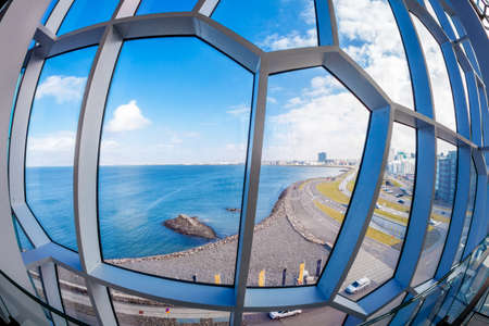 A fisheye view to Reykjavik coastline through the windows of modern buildingの写真素材