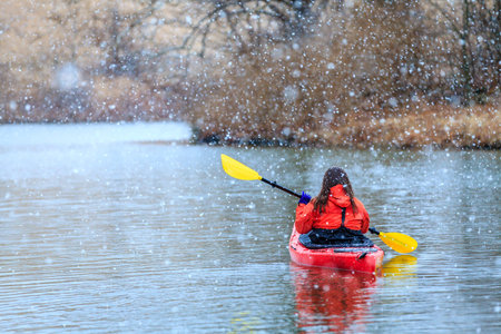 Kayaking on a lake in winterの写真素材