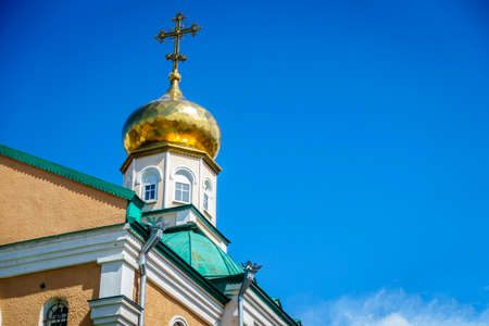 Classic gold-plated onion dome of a Russian Orthodox church against blue skyの写真素材