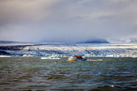 Jokulsarlon Lagoon, Iceland - September 13, 2013: Amphibious vehicle takes tourists on iceberg watching tour in Jokulsarlon glacier lagoon in Southern Icelandのeditorial素材