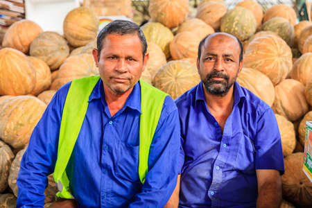Dubai, June 4, 2016: farmers in front of pile of squashes at the fruit and vegetable market in Dubai, UAEのeditorial素材