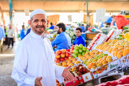 Dubai, June 4, 2016: a local shopper in front of a fruit counter at the fruit and vegetable market in Dubai, UAEのeditorial素材