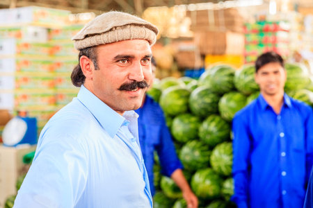 Dubai, June 4, 2016: portrait of local vendor at the fruit and vegetable market in Dubai, UAE