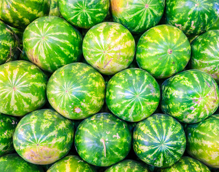 A stack of watermelons at the fruit and vegetable market in Dubai, UAEの写真素材