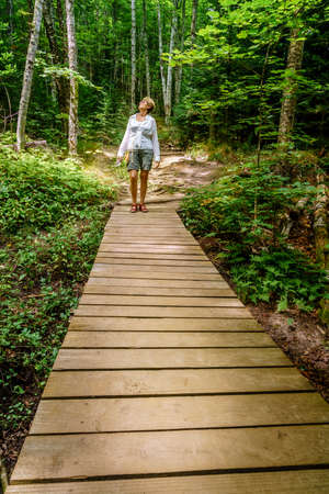 A woman on a trail in Pictured Rocks National Lakeshore, Michiganの写真素材