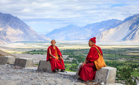 Nubra Valley, Ladakh, India, July 14, 2016: two monks near Diskit Monastery overlooking Nubra Valley in Ladakh region of Kashmir, Indiaのeditorial素材