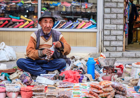 Leh, Ladakh, India, July 14, 2016: local man is selling spices on a sidewalk market in Leh, Ladakh district of Kashmir, Indiaのeditorial素材