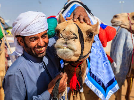 Dubai, United Arab Emirates - March 25, 2016: Camel handler with his animal at Dubai Camel Racing Clubのeditorial素材