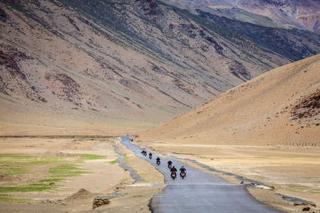 Motorcyclists on the road through Changthang plateau in Ladakh region of Kashmir, Indiaの写真素材