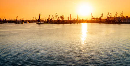 Commercial port of the city of Varna, Bulgaria at sunsetの写真素材