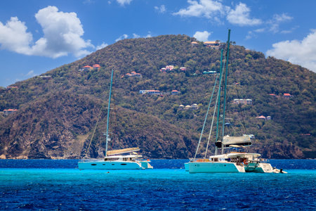 Luxury sailing catamarans near a resort island in BVI