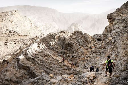 Ras Al Khaimah, UAE, January 13, 2017: A group of hikers on a trail in Hajar mountains in Ras Al Khaimah, UAEのeditorial素材