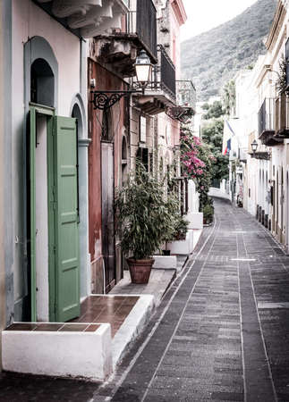View down a pedestrian street in the town of Santa Marina on Salina island in Italyの写真素材