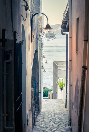 View down a pedestrian street in the town of Santa Marina on Salina island in Italyの写真素材