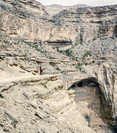 A hiker on Balcony Walk trail on Jebel Shams Mountain in Omanの写真素材
