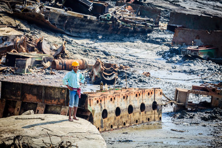 Chittagong, Bangladesh, December 23, 2017: A worker stands among scrap from dismantled ships at one of many ship-breaking yards in Chittagong, Bangladeshのeditorial素材