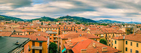 Panoramic view of rooftops and suburban hills in Bologna, Italyの写真素材