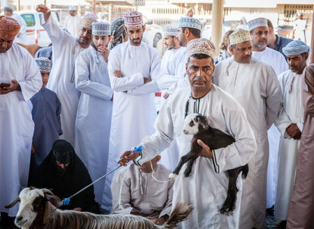 Nizwa, Oman, December 2, 2016: Goat sellers at the Friday goat market in Nizwa, Oman